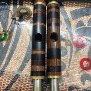 Custom wood piccolo headjoints with alternating dark and light wood rings, handcrafted by Jeff Weissman
