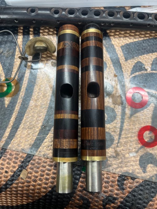 Custom wood piccolo headjoints with alternating dark and light wood rings, handcrafted by Jeff Weissman