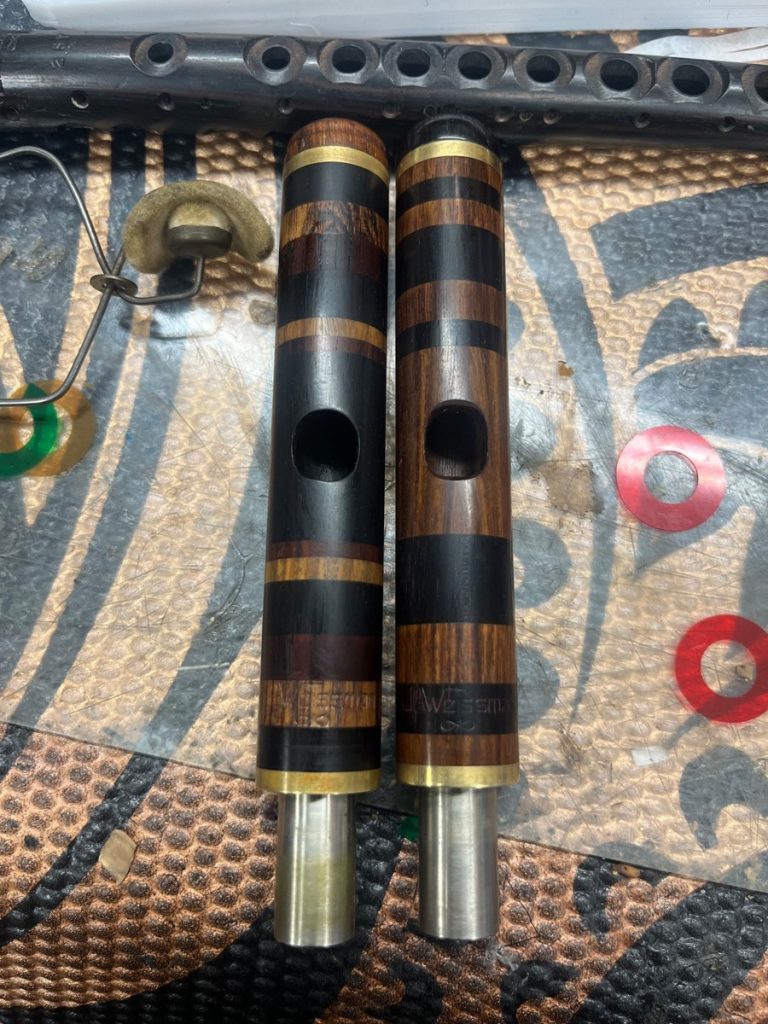 Custom wood piccolo headjoints with alternating dark and light wood rings, handcrafted by Jeff Weissman
