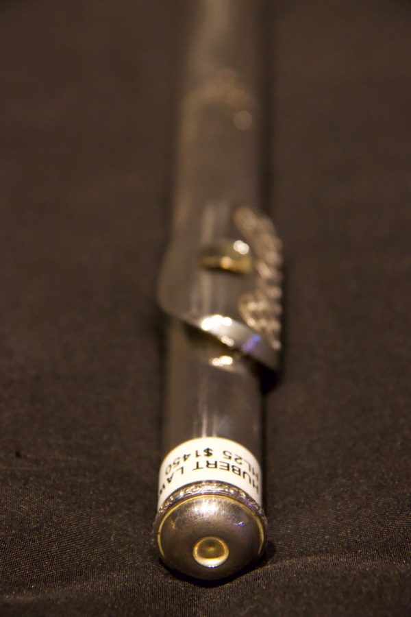 Close focus on perforated lip plate pattern extending across lip plate of silver headjoint