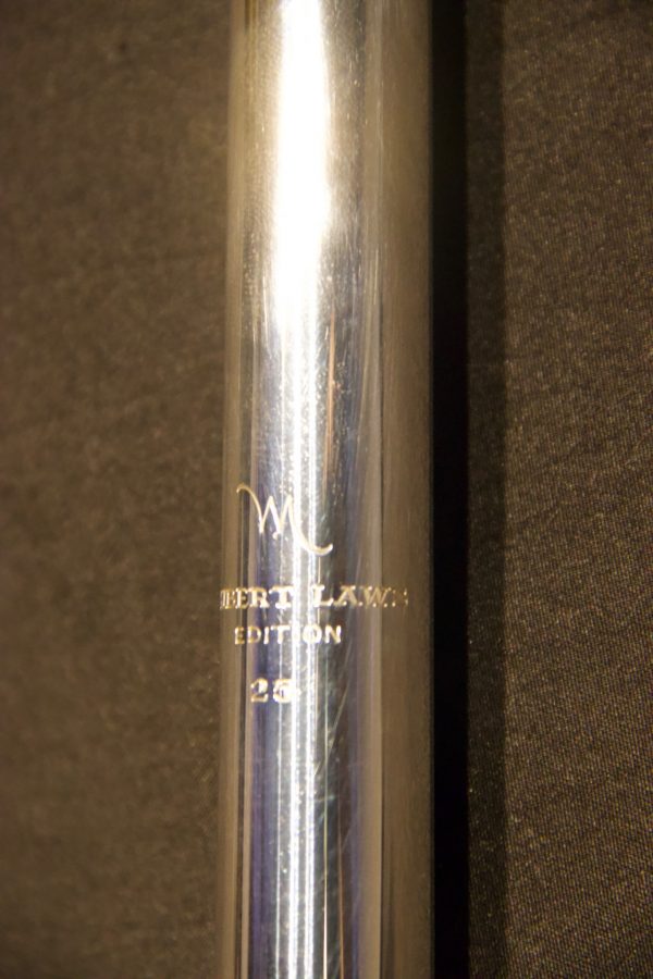 Detailed view of sterling silver tube with Hubert Laws Edition engraving, serial number visible