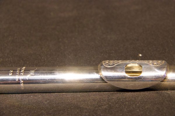Angled side shot of Hubert Laws headjoint showing perforated lip plate and silver body