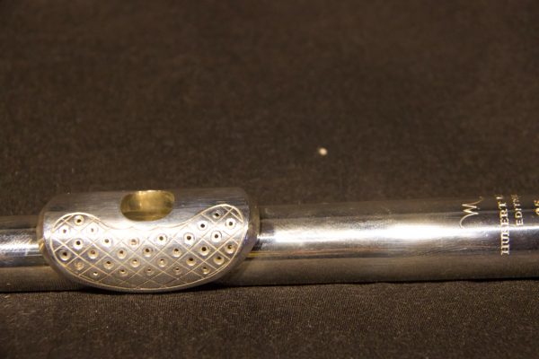 Close-up of perforated lip plate design with diamond pattern engraving on Hubert Laws headjoint