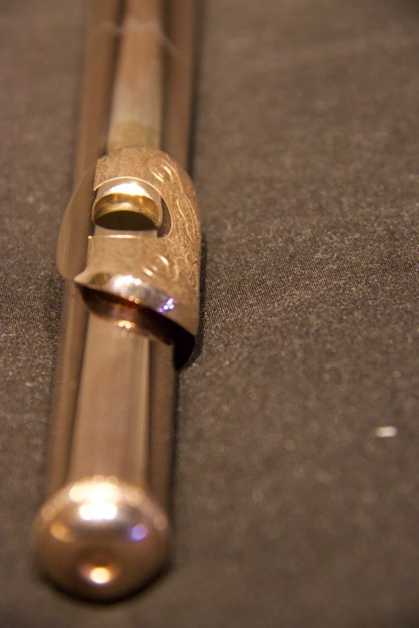 End cap view of silver flute headjoint with gold-plated engraved lip plate