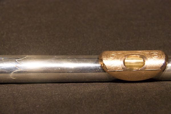 Close-up of engraved gold lip plate on Jeff Weissman silver flute headjoint