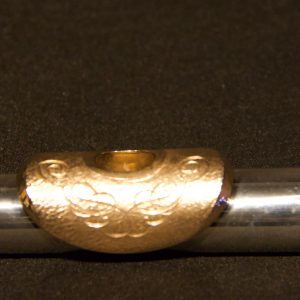 Front view of engraved gold-plated lip plate on Weissman silver headjoint