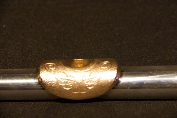 Front view of engraved gold-plated lip plate on Weissman silver headjoint