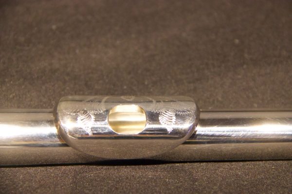 Front view of engraved lip plate on Jeff Weissman solid silver flute headjoint
