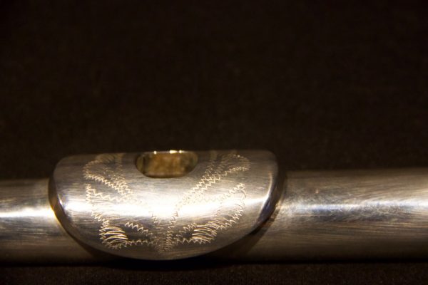 Angled view of Jeff Weissman solid silver headjoint showing alternate engraving