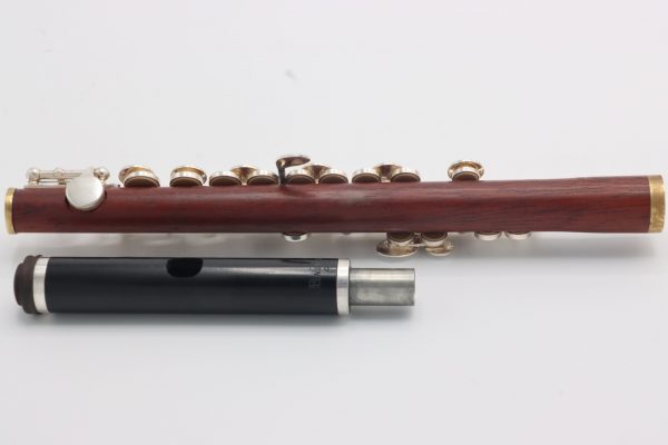 Sedona Rosewood Piccolo with grenadilla headjoint – angled view highlighting silver-plated keys and visible pads against the rosewood body