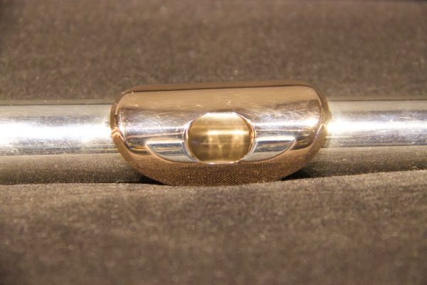 Centered close-up of gold lip plate on Weissman McKenna silver flute headjoint