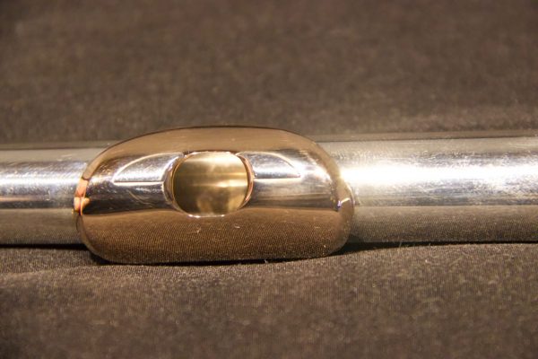 Angled view of Weissman McKenna silver flute headjoint with gold lip plate