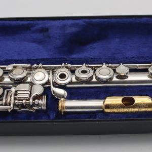 Emmerson Soloist flute displayed in an open blue velvet-lined case, showing full body, keys, and gold lip plate headjoint