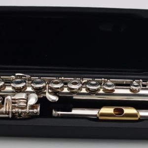 Jupiter intermediate open-hole flute with silver headjoint and gold-tone lip plate resting in an open black hard case.